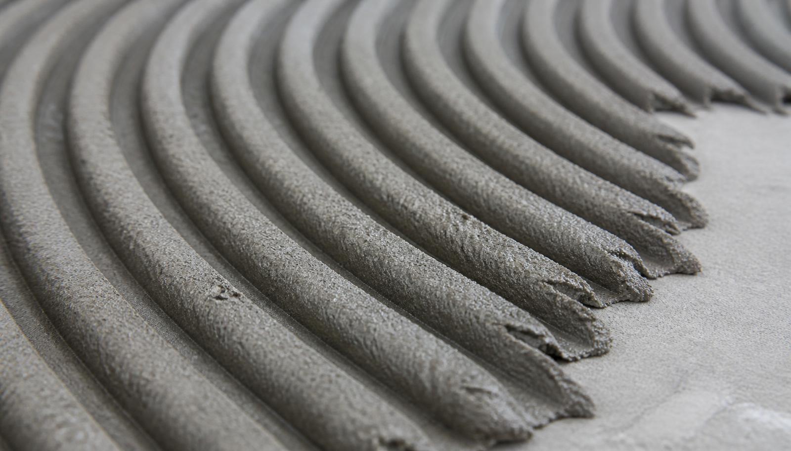 Close-up of Primo Fixx tile adhesive combed into even ridges with a square notched trowel
